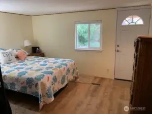 Primary bedroom with door to the new covered deck.