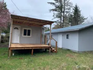 The new covered porch at the rear of the house and the entrance to the bunkroom and bathroom behind the garage.
