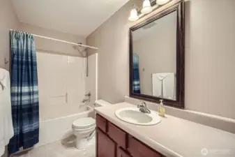 Bathroom upstairs with vanity and shower large and large mirror