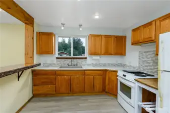 The window above the sink brings in natural light, creating an inviting workspace that blends both charm and functionality.