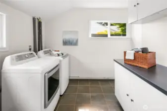 Large laundry/utility room with plenty of space for storage and organization.