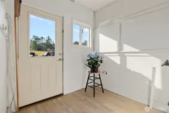 Laundry area just inside the back door - very practical for coming in front work or play.