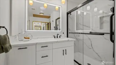 Programable vanity mirror. Quartz counters and marble flooring.