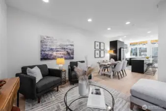 Gather around this dining space, where modern simplicity meets thoughtful design. Adjacent to the sleek kitchen, it offers a perfect setting for meals shared with loved ones, enhanced by warm natural tones and abundant lighting. Photos of home with similar layout, finishes & fixtures.