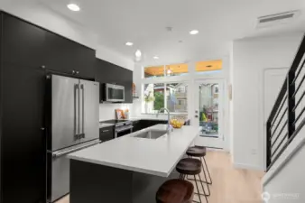 A closer look at the kitchen reveals a harmonious blend of sophistication and practicality. Enjoy the seamless flow of this space, ideal for cooking, entertaining, or simply admiring the thoughtful design. Photos of home with similar layout, finishes & fixtures.