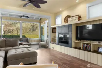 Built in entertainment center with shelves and electric fireplace