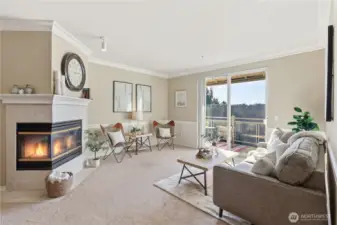 Light-filled living area with comfortable open-concept layout and cozy gas fireplace