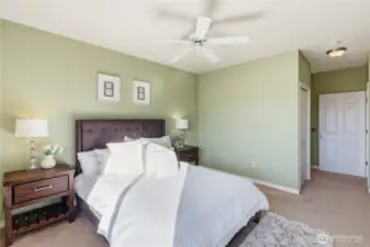 Peaceful primary bedroom offering privacy and generous space with walk-in closet