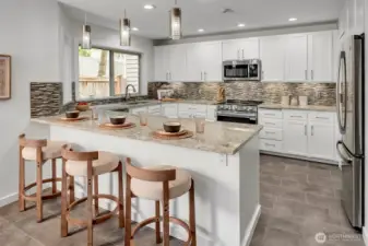 Warm, inviting...NEW(er) SS appliances, custom tile touches, new lighting.....new, fresh and clean interior paint! This kitchen has a walk-in pantry, ideal island w/counter seating + lots of storage too! Large, open, bright and beautiful in every way is this home in the desirable community of Walnut Hills in Redmond.