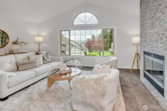 5 steps from the main floor is this stunning + serene living room w/custom tile floors and fireplace. This space is filled with light, and is beyond generous in size. You will LOVE the vaulted ceilings, floor to ceiling custom fireplace and on those clear PNW days....the VIEWS of the Cascade mountain range will make you smile!