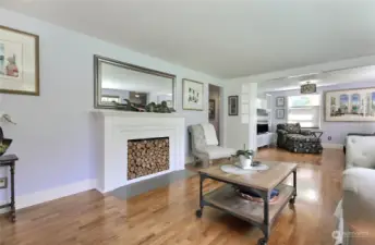 Open concept family room with wood fireplace and entertainment area.