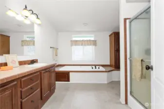 This ensuite bath has a jetted tub and a walk in shower