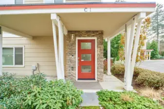 Cute covered entry with additional space for chairs or a bench.