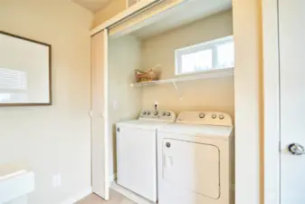 Off the hallway on the upstairs level is the washer and dryer and additional storage.