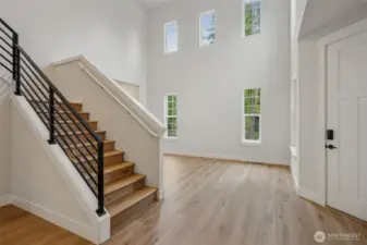 Beautiful entry, soaring ceiling at entry & living room.  Gorgeous metal railing.  LVP on entire main level and at upper stairs and hall