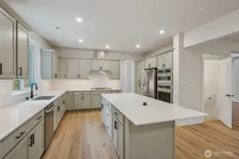 Beautiful Kitchen with painted gray cabinets, quarts counters, GE Cafe' appliances; Microwave, oven, gas stove & refrigerator.  Black hardware, including faucet.  Deep single basin sink and garbage disposal.