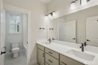 Upper bath room; Large tile flooring, dual sinks, quartz counters, black hardware, plumbing fixtures and lighting. and separate tub/shower and toilet room.