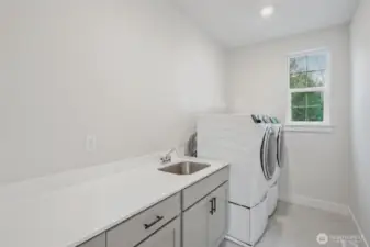 Now wouldn't doing laundry in this room be fun?  Cabinets, sink and washer and dryer included!
