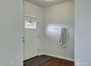 The entry is cozy and tidy and ready to welcome family and friends.