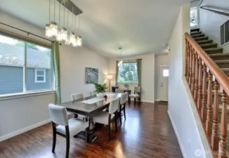 Looking into the dining room from the kitchen, with the stairs leading up to the bedrooms.