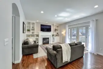 With built-ins and a fireplace, you can curl up an relax. French doors to the right lead to the backyard and deck.