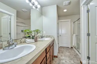This is the bathroom in the primary suite. The water closet is to the right and the walk-in closet is straight ahead.