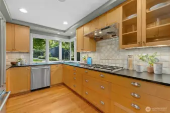 A warm and inviting kitchen. Plenty of counter space. A gas range. Generous cabinet space with under cabinet lighting, 2 sinks and updated appliances.