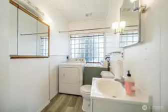 Half bath and laundry area.