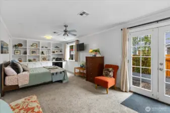 Spacious primary suite with built-ins and French doors to the garden patio.