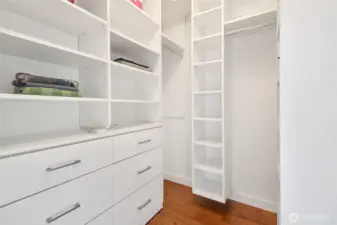 Another large walk-in closet with organizer is located in the primary bedroom.
