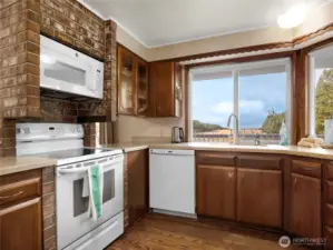 Kitchen with eating space. This room faces the deck which overlooks the dunes and has a full ocean view.