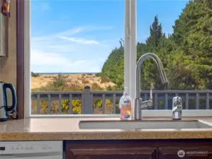 Kitchen with eating space. This room faces the deck which overlooks the dunes and has a full ocean view.