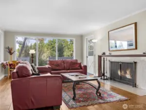 Living room (upstairs) with ocean and territory views and fireplace.