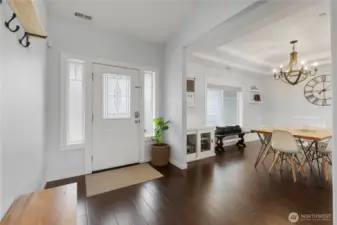 Looking back at the front door and peeking into the dining room.