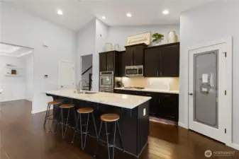 The large kitchen is the perfect gathering place, with plenty of room for eating, prepping, and cooking. Note there is a large pantry through the door.