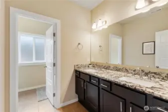 Guest bathroom with two sinks and separate shower/toilet area.