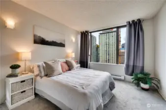 Spacious bedroom with huge window to enjoy the sparkling city views.