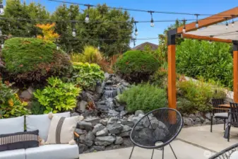 Full landscape renovation with hot tub, shed, outdoor power supply, grow beds, custom gazebo, waterfall, entry gates and light fixtures.