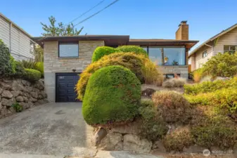 Elevated home position provides abundant natural light with off-street parking for 2 cars. 240v outlet added to garage for fast electric car charging.
