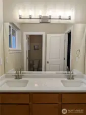 Remodeled hallway bathroom with NEW quartz, undermount sinks, lighting, faucets & herringbone vinyl floors!