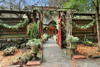 Large rock wall is original to property and the wood fencing was added later for complete privacy behind the wall! Gated entranace goes over bridge to front of log home. Water feature/pond with Koi fish.