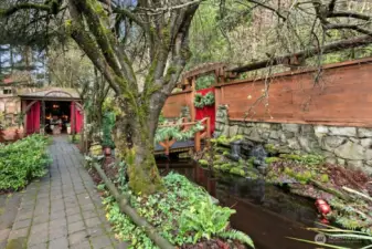 View of main gate entry and Koi pond/water feature and paver pathway
