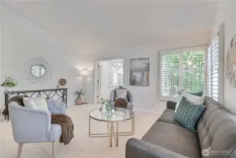 Living Room flows to the amazing   sunroom. This home has it all! Front large new patio, back deck, and a sun room!