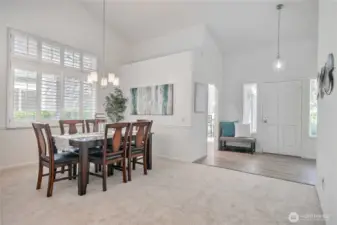 Open dining room with vaulted ceiling will fit any size table.