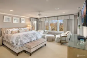 Luxurious master suite with views of water