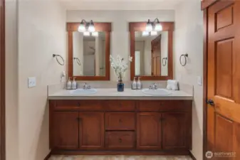 Thoughtfully designed luxurious primary suite features a custom 5-piece bath complete with a spa-like soaking tub, dual vanities, a walk-in shower, and a custom-tailored bidet.