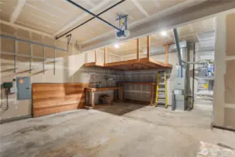 The spacious two-car garage is designed with built-in shelving, offering ample storage space for tools, sports equipment, and seasonal items.