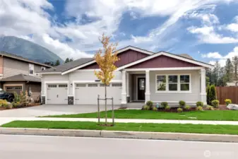 Large front porch and three car garage.