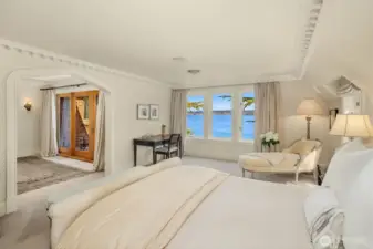Upstairs enjoy the primary suite with private balcony and sweeping views.