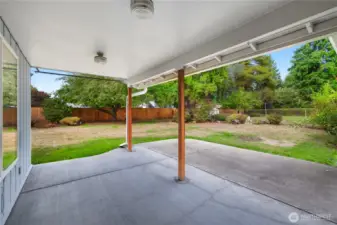 Covered patio, perfect for entertaining, with views of the backyard.